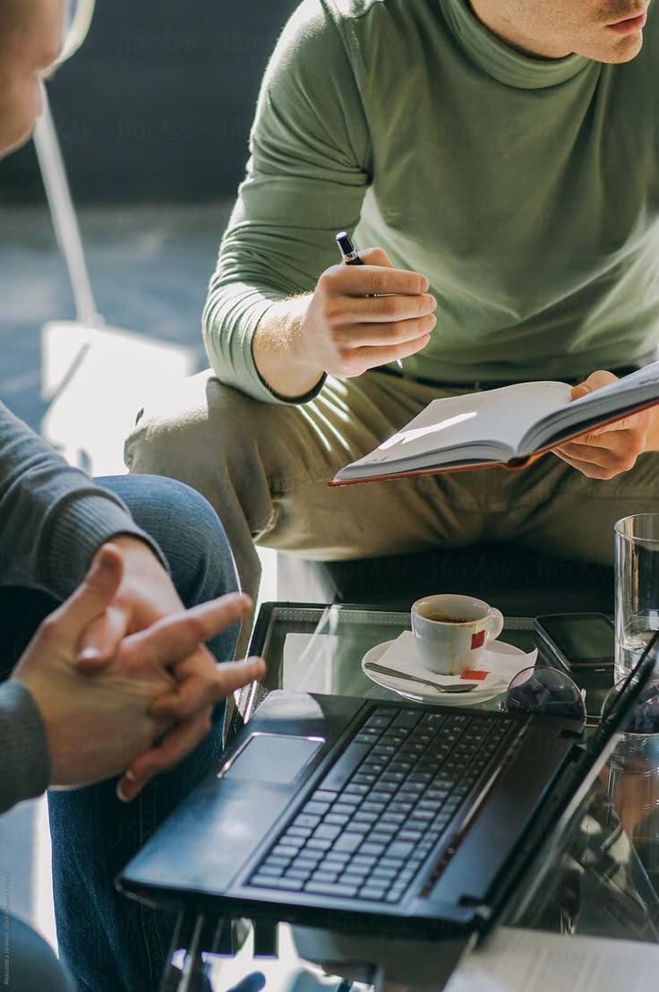 A notebook and laptop during a personal planning conversation